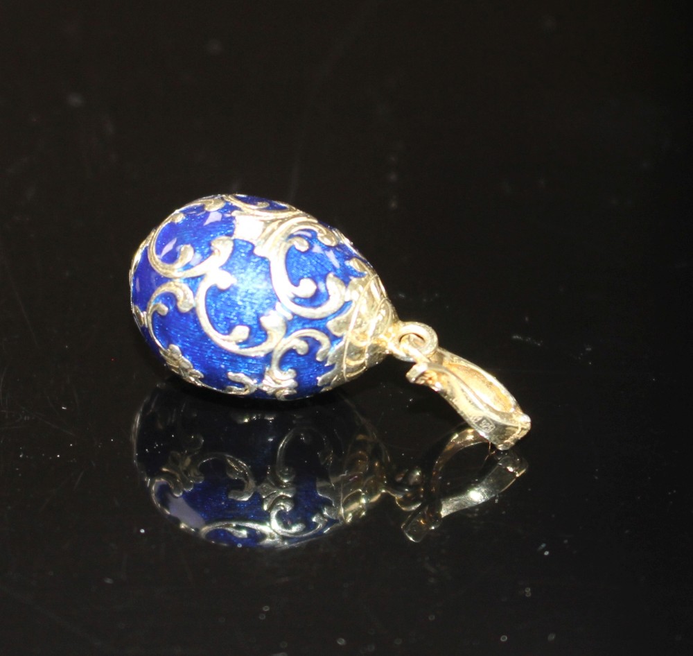 A modern 925 gilt white metal, blue enamel and diamond set egg shaped pendant, egg 20mm, gross weight 4.1 grams.